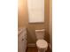 Close-up of a bathroom toilet and granite countertop, featuring a window with natural light at 2701 S Dellwood Dr, Eustis, FL 32726
