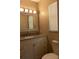 Bathroom vanity with granite countertop, modern fixtures, framed mirror, and natural light from the window at 2701 S Dellwood Dr, Eustis, FL 32726
