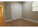 Bedroom features tile floors, a double-door closet, and natural light from the window at 2701 S Dellwood Dr, Eustis, FL 32726