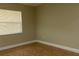 Bedroom boasts tile floors, a window with blinds, and neutral walls, offering a serene ambiance at 2701 S Dellwood Dr, Eustis, FL 32726