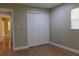 Cozy bedroom with a closet, neutral paint, and warm-toned tile flooring, creating a comfortable space at 2701 S Dellwood Dr, Eustis, FL 32726