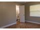 Bedroom view into a bathroom featuring neutral paint, warm-toned tile flooring, and natural light at 2701 S Dellwood Dr, Eustis, FL 32726