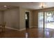 The dining area has sliding glass doors to the yard and is open to the kitchen with neutral walls at 2701 S Dellwood Dr, Eustis, FL 32726