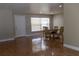 Bright dining room features tile flooring, a window with blinds and a round wooden table with chairs at 2701 S Dellwood Dr, Eustis, FL 32726