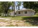Side view of a single story home with a well-maintained lawn and mature trees at 2701 S Dellwood Dr, Eustis, FL 32726