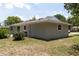 Back corner view of a well-maintained single story home with new roof and green lawn at 2701 S Dellwood Dr, Eustis, FL 32726