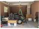 A residential garage cluttered with miscellaneous items at 2701 S Dellwood Dr, Eustis, FL 32726