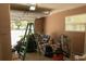 A residential garage with an open door. Debris is scattered on the floor at 2701 S Dellwood Dr, Eustis, FL 32726