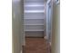 Hallway features convenient built-in shelving providing ample storage space and tile flooring at 2701 S Dellwood Dr, Eustis, FL 32726