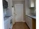 Bright kitchen features granite countertops, tile flooring, and modern white cabinets and appliances at 2701 S Dellwood Dr, Eustis, FL 32726