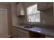 This bright kitchen features a double sink, granite countertops, and a window at 2701 S Dellwood Dr, Eustis, FL 32726