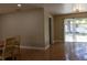 Cozy living room featuring tile flooring, neutral paint, and a sliding glass door to the backyard at 2701 S Dellwood Dr, Eustis, FL 32726