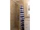 Shower with tile walls, granite countertop vanity, and blue-striped shower curtain at 2701 S Dellwood Dr, Eustis, FL 32726