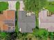 Overhead shot shows home's roof, manicured lawns, landscaping, and proximity to neighbors at 2712 Plainridge Loop, The Villages, FL 32162