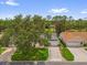 Aerial view of the home showing its well-maintained lawn, mature trees, and desirable neighborhood setting at 2712 Plainridge Loop, The Villages, FL 32162
