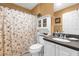 Bathroom featuring a shower with a floral curtain, white cabinetry, and light-colored walls at 2712 Plainridge Loop, The Villages, FL 32162