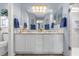 Stylish bathroom featuring double sinks, vanity, and a glass-enclosed shower at 2712 Plainridge Loop, The Villages, FL 32162