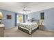 Tranquil bedroom with blue walls, a large window, and a comfortable-looking bed at 2712 Plainridge Loop, The Villages, FL 32162