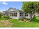 Well-maintained home exterior showcasing lush lawn, mature tree, and manicured landscaping at 2712 Plainridge Loop, The Villages, FL 32162