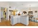Bright eat in kitchen with an island and view of the living and dining areas with wood floors at 2712 Plainridge Loop, The Villages, FL 32162