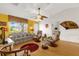 Comfortable living room with a fan, a plush sofa, and a sunny window at 2712 Plainridge Loop, The Villages, FL 32162