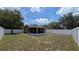 Backyard featuring a screened-in porch and a newly installed white fence at 2718 Lorraine Dr, Leesburg, FL 34748