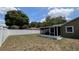 Backyard featuring a screened-in porch and a newly installed white fence at 2718 Lorraine Dr, Leesburg, FL 34748