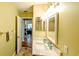 Bathroom with vanity sink and mirror; view to living room in the background at 2718 Lorraine Dr, Leesburg, FL 34748