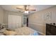 Bedroom featuring a ceiling fan, a window with curtains, and a closet at 2718 Lorraine Dr, Leesburg, FL 34748