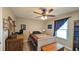 Bedroom features a ceiling fan, a bookcase, and a window with blind for natural light at 2718 Lorraine Dr, Leesburg, FL 34748