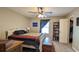 Bedroom with carpet, ceiling fan, window, and door to closet at 2718 Lorraine Dr, Leesburg, FL 34748