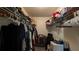 Spacious walk-in closet with shelves and racks for optimal storage and organization at 2718 Lorraine Dr, Leesburg, FL 34748