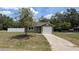 Charming single-story home with a well-maintained lawn and an attached one-car garage at 2718 Lorraine Dr, Leesburg, FL 34748