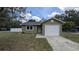 Charming single-story home with a well-maintained lawn and an attached one-car garage at 2718 Lorraine Dr, Leesburg, FL 34748
