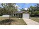 Charming single-story home with a well-maintained lawn and an attached one-car garage at 2718 Lorraine Dr, Leesburg, FL 34748