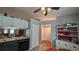 View of the kitchen with white and dark cabinets, a sink, and a glimpse of a dining area at 2718 Lorraine Dr, Leesburg, FL 34748