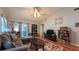 Open living room boasts vaulted ceilings, a cozy sofa, and an inviting atmosphere for relaxation and entertainment at 2718 Lorraine Dr, Leesburg, FL 34748