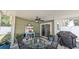 Enclosed patio with table, chairs, a ceiling fan, and grill, inviting outdoor gatherings at 2718 Lorraine Dr, Leesburg, FL 34748