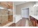 Bright bathroom showcasing glass enclosed shower, soaking tub, double sinks, and neutral color palette at 2889 Columbus Ave, Clermont, FL 34715