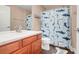bathroom featuring single sink with cherry cabinet, hardwood floors, and a shower-tub combo at 2889 Columbus Ave, Clermont, FL 34715