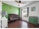 Bedroom featuring hardwood floors, crib, gray blinds, and a ceiling fan at 2889 Columbus Ave, Clermont, FL 34715