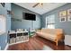 Bedroom featuring neutral walls, hardwood floors, ceiling fan, and a small futon at 2889 Columbus Ave, Clermont, FL 34715