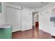 Bedroom featuring hardwood floors and a view into an ensuite bathroom at 2889 Columbus Ave, Clermont, FL 34715