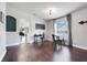 Elegant dining room with hardwood floors, modern lighting, and a view into the living area with an arched doorway at 2889 Columbus Ave, Clermont, FL 34715