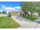 Well maintained single-story home with a concrete driveway and mature landscaping at 2889 Columbus Ave, Clermont, FL 34715