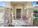 Inviting front entrance with decorative stone pillars and a charming, paneled front door at 2889 Columbus Ave, Clermont, FL 34715
