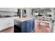 Kitchen features a dark blue island with seating, white cabinets and stainless steel appliances at 2889 Columbus Ave, Clermont, FL 34715