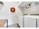 Functional laundry room featuring modern appliances, shelving, and neutral paint at 2889 Columbus Ave, Clermont, FL 34715