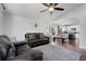 Open-concept living room featuring hardwood floors and view into the modern kitchen with an island and a cozy seating area at 2889 Columbus Ave, Clermont, FL 34715