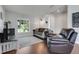Cozy living room featuring hardwood floors, a large window offering ample natural light, and comfortable seating at 2889 Columbus Ave, Clermont, FL 34715